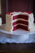 Red velvet cake on a cake stand, sliced