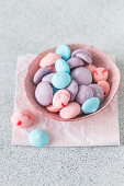 Colorful meringue kisses in a bowl