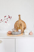 Arrangement of pumpkins and wooden board on white base unit