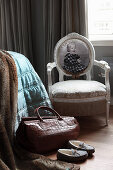 Leather bag in front of medallion chair with photo on backrest