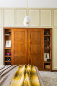 Double bed and fitted wardrobes with walnut insert in bedroom