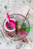 Cold borsch served in white bowl and decorated with dill