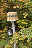 Hand-crafted standard lamp made from weathered branch and knitted lampshade