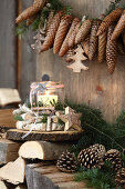 Garland of fir cones above candle lantern in wreath of birch branches