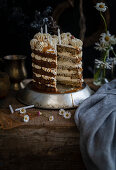 Earl Grey layer cake, slice taken out, with birthday candles blown out