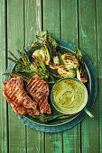 Chargrilled spring greens with lemon pork chops