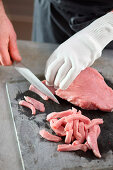 Topside of veal being chopped