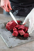 Beef being diced for goulash