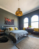 Bedroom with grey walls and mustard-yellow accents