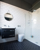 Black-and-white bathroom with hexagonal floor tiles and walk-in shower