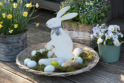 Basket bowl with moss as Easter basket with Easter bunny and Easter eggs