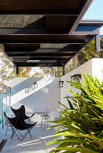 Classic chairs on a white, brick terrace