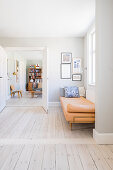 Couch next to double doors leading into retro-style living room