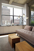 Pale sofa and coffee table below window