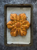 Sweet Christmas bread in a star shape with cinnamon and almonds
