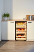 DIY vegetable rack made from crates in kitchen