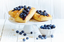 Puff pastry tartlets with blueberries on a cake stand