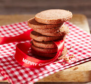 A stack of gingerbread biscuits with a ribbon for Christmas