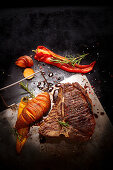 Grilled T-bone steak with hasselback sweet potatos and peppers