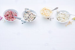 Raspberry and oat muesli; muesli with apples, walnuts and raisins; orange semolina pudding, and pear yoghurt muesli