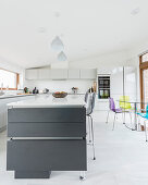 Glossy cabinets and dining area in modern kitchen