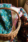 Floral blankets in wicker basket