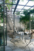 Garden furniture under pergola on roof terrace in New York