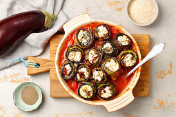 Aubergine and courgette rolls with feta cheese in tomato sauce