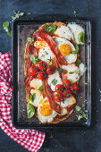 Pizza with egg, bacon, cherry tomatoes and mozzarella