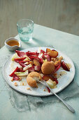 Red and yellow chicory salad with baked mozzarella, red plums and nut dressing