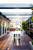 Modern garden furniture on the covered terrace with wooden deck