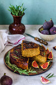 Inverted pie in a cut with figs, rosemary and honey on a concrete background