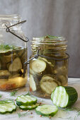 Sliced Pickling Cucumbers Marinating in Vintage Glass Jars