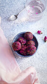 Healthy truffle candies made of dates, cocoa and cashew and covered with rose petals