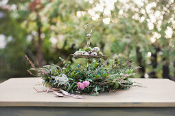 Luxuriant wreath around quail eggs on cake stand