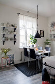 Dining table in black-and-white kitchen-dining room