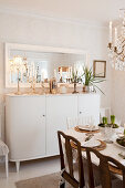 Tall sideboard with Christmas decorations in Scandinavian dining room