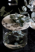 Eucalyptus twigs in vase with perforated lid made from modelling clay