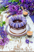 Festliche Brombeertorte mit Schokoladenglasur und blauen Macarons