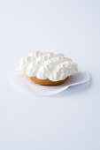 A mini tartlet with rhubarb and meringue on a white background