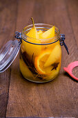 Poached pears with oranges and spices in a flip-top jar