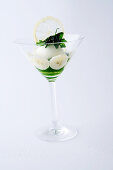 Lemon sorbet with parsley coulis and bananas served in a stemmed glass