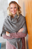 A blonde woman wearing a grey shawl