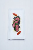 Lamb loin in a rosemary and cumin crust with beetroot, tomato chutney and gorgonzola fondant