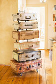 Handmade chest of drawers made from vintage suitcases and metal frame