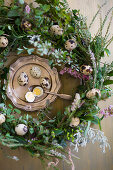 Easter wreath and quail eggs on silver tray