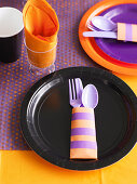 Children's table set in black, orange and purple for a Halloween party