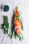 Raw red scorpion fish, with rosemary and thyme