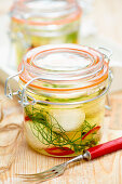 Pickled goat's cheese with lemons, fennel and chilli in glass jars