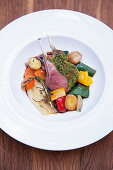 A rack of lamb with a herb crust and potato peperonata